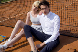 andydonb man and girl sit on tennis ground